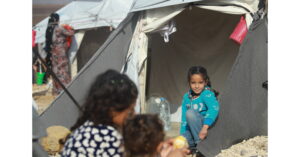 CH11267189-Amal--sits-in-the-entrance-of-their-family-tent--2