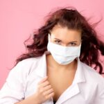 Young female doctor in mask