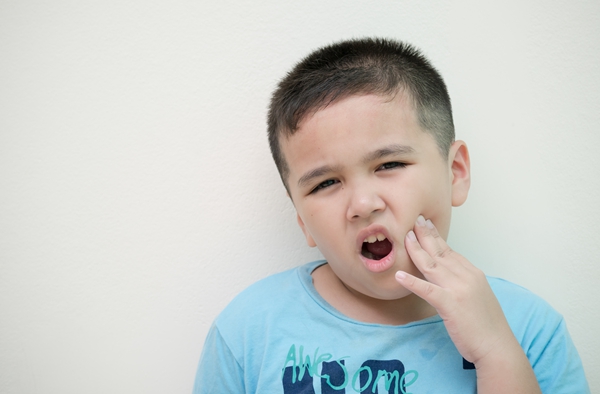 Portrait boy has a toothache.Oral Care Concepts