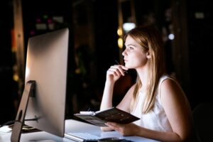 Businesswoman in her office at night working late.