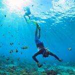 Young man in snorkelling mask dive underwater