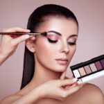 Makeup artist applies eye shadow