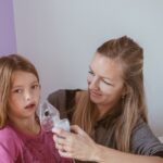 Mother inhaling daughter