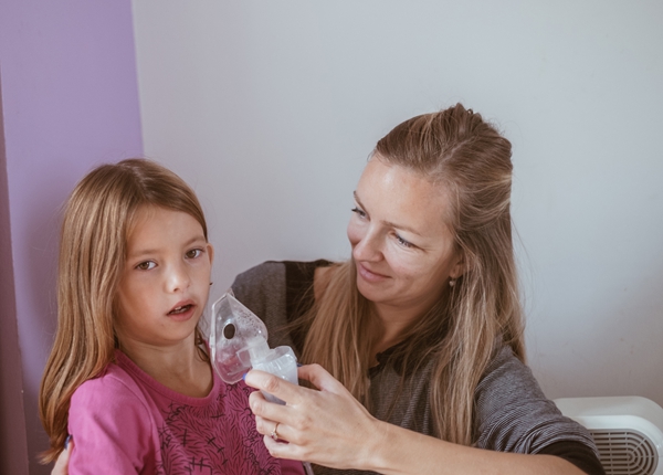 Mother inhaling daughter