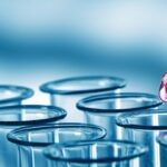 Pipette adding fluid to one of several test tubes .medical