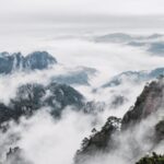 An,Aerial,View,Of,Mount,Huangshan,Covered,With,Clouds,In