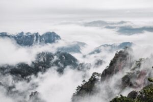 An,Aerial,View,Of,Mount,Huangshan,Covered,With,Clouds,In