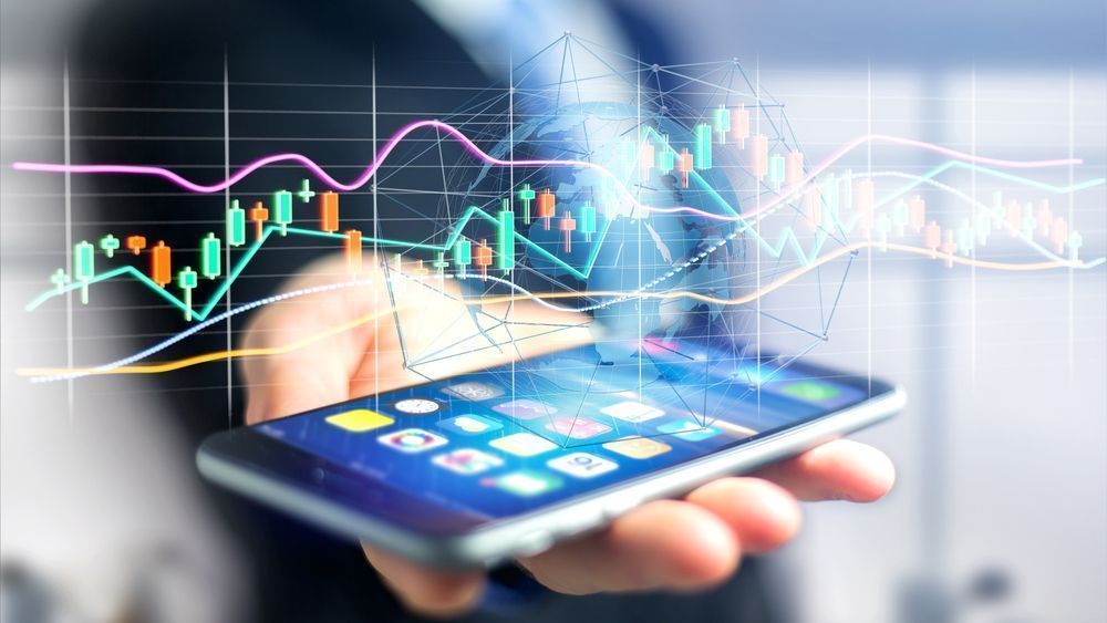 Businessman usng a smartphone with a 3d render Stock exchange trading data information display on a futuristic interface