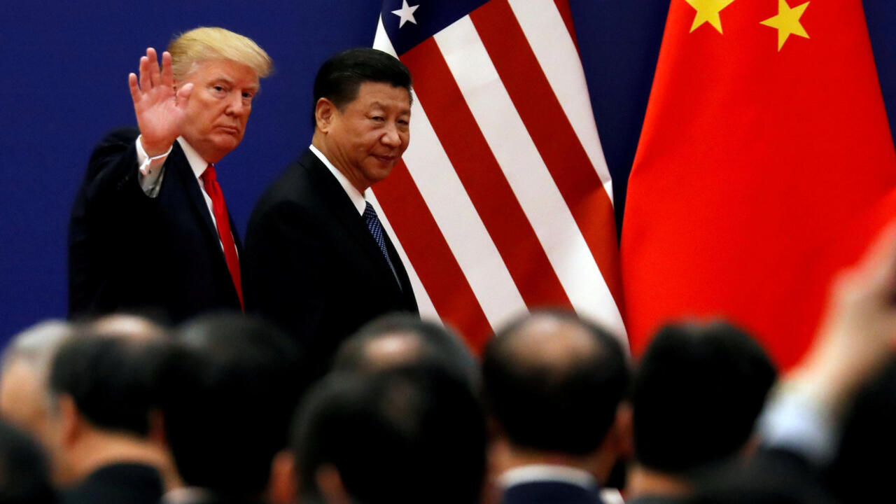 FILE PHOTO: U.S. President Donald Trump and China's President Xi Jinping meet business leaders at the Great Hall of the People in Beijing